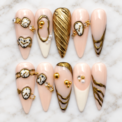 Luxury pink and gold press on nails with vintage clock charms, pearls, and 3D gold accents on white marble.