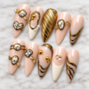 Elegant pink and gold press on nails with metallic gold swirls, vintage clock designs, and 3D embellishments.