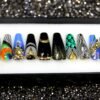 Black and gold coffin press on nails with zebra stripes, peacock swirl, gold spikes, crystals and gold glitter