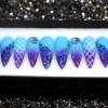 Sky blue to violet ombré stiletto press on nails with blue glitter tips, mermaid scales and shell ridges