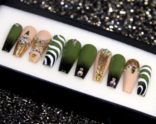 Olive green coffin press-on nails from the opposite end of the tray: gold foil panels, crystals and swirl stripes