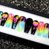 Coffin press-on nails from the other end of the tray: black gloss, neon watercolour splashes and flame details