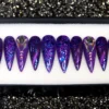 Purple to blue ombré stiletto press on nails with chunky glitter, a cat-eye stripe and a fan of iridescent crystals