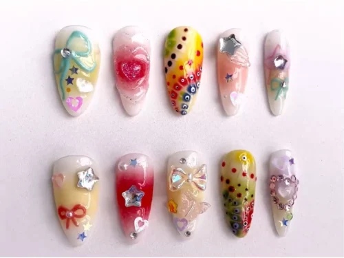 Almond press-on nails in a second layout, with clear iridescent charms, a red gradient nail with a gem star and small hearts
