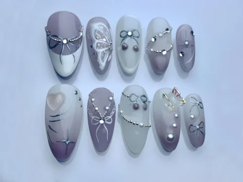 Mauve almond press on nails with silver wire bows, bead swags, painted white butterfly wings and pearls