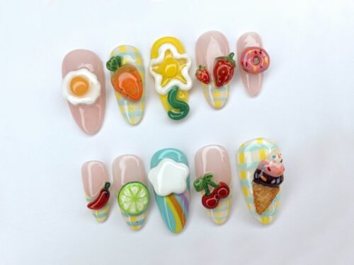 Food-charm press-on nails in a mirrored layout, with a lime slice, red chili, cherries and a yellow star outline