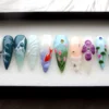 Teal and lilac stiletto press on nails with a hand-painted orange koi, pink tulips, a 3D flower and dew drops