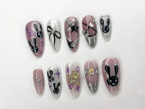 Black bunny press-on nails from the other side, with a gold gem star, purple stars, a black star nail and chrome tips