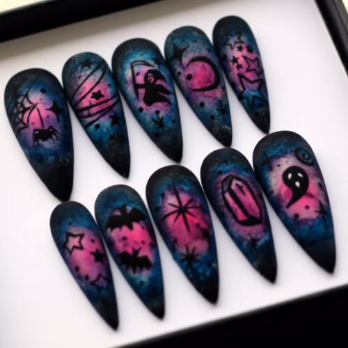 Halloween galaxy press-on nails from another angle, with a coffin, ghost, bat, starburst and crescent moon