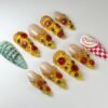 Stiletto press-on nails on grey, sculpted as pizza slices with pepperoni and olives, plus a checkered pizza-box nail