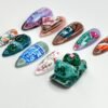 Japanese-style press-on nails from another angle, with a large jade green 3D figure, pink blossoms and a blue tile pattern