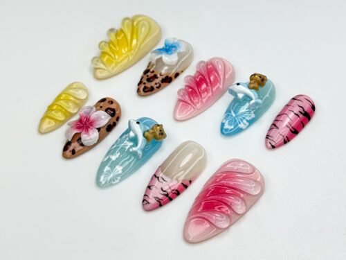 Jungle press-on nails from another angle, with a blue flower, a pink flower on leopard print, striped nails and a dolphin