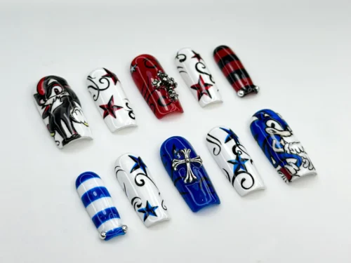 Press-on nails laid flat: red and navy stars, blue and white stripes, silver cross charms, red plaid and swirls