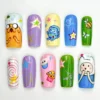 Bright square press on nails hand-painted with a yellow cartoon dog, a game console, a bee and stars