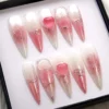 White to rose ombré stiletto press-on nails in a black box, with silver chrome vine lines and raised glossy pink hearts