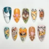 Almond press on nails hand-painted with cartoon cats, a 3D hooded kitten, orange paws and Save a Kitty lettering