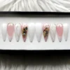 Milky white and sheer pink stiletto press on nails with silver glitter flakes, silver lines and abalone shell chips