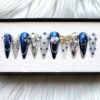 Navy chrome and white stiletto press on nails with a lilac 3D butterfly, silver initial, bow, roses and crystals