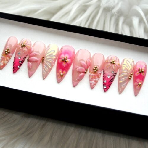 Pink 3D flower press-on nails from another angle, with sculpted petals, butterfly-wing designs, gold beads and crystals