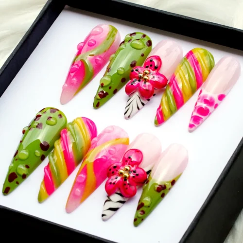 Tropical stiletto press-on nails from another angle: pink hibiscus, olive green dotted nails and striped swirl nails