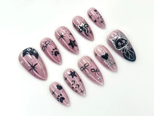 Mauve chrome almond press-on nails from another angle, with paw prints, black bows, hearts and a cat-face charm