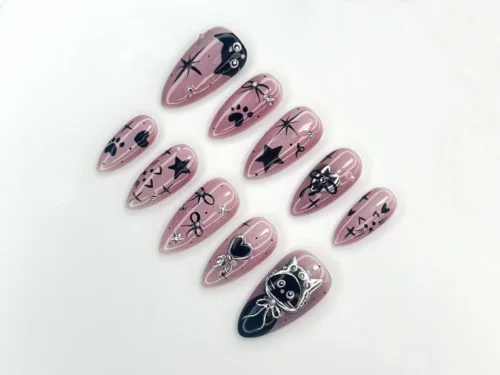 Mauve pink chrome almond press-on nails flat on white, with black cat silhouettes, hearts, stars and silver sparkle lines