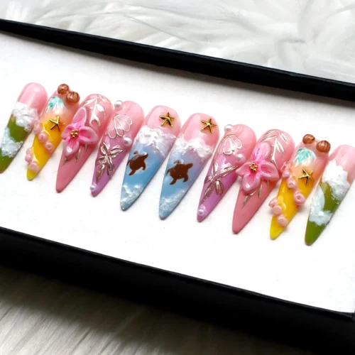 Press-on nails from the other end of the tray: pink to lime tips, white sea foam, painted turtles and gold stars
