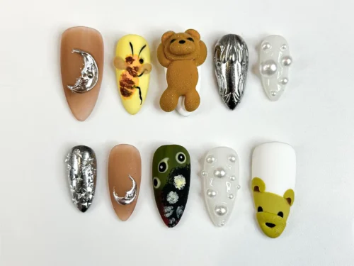 Almond press on nails with a fuzzy 3D teddy bear, a painted bee, a silver moon, chrome textures and pearls