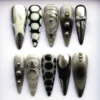 Gunmetal silver chrome stiletto press on nails with sculpted swirls, a 3D bow, a star and chrome beads