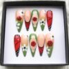 Nude and green stiletto press on nails with 3D red ladybugs, white daisies and red butterfly-wing tips