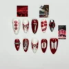 Red and white almond press on nails with silver 3D bows, lace scallops, hand-lettered names and a silver ring band