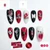 Black, red and white almond press on nails with hand-lettered fan names, a glitter 7 and silver-outlined logo