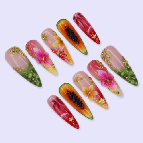 Tropical press-on nails fanned out on lilac: papaya seed nails, hibiscus, lime tips and tiny gold starfish