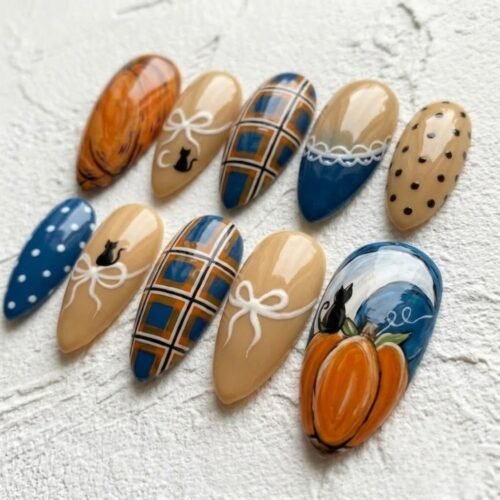 Autumn-themed press-on nails featuring intricate pumpkin and black cat designs.