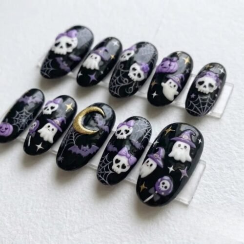 Black Halloween press-on nails from another angle, showing ghosts in purple witch hats, bats, spiderwebs and a gold moon