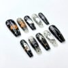Press-on nails featuring a magic cauldron design against a spooky black-and-white background.