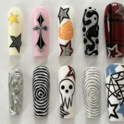 Skull and cross press-on nails in red plaid, white, pink and silver with a skull, a black cross, spirals and stars