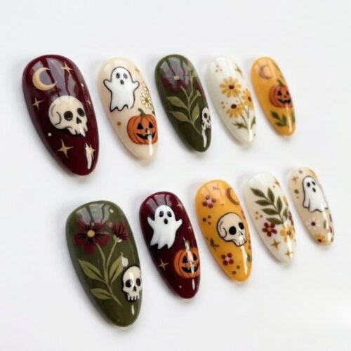 Almond press-on nails in burgundy, olive, cream and mustard with small ghosts, jack-o'-lanterns and skulls on white