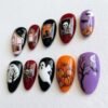 Press-on nails with a spooky white ghost design.