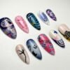 Halloween-themed press-on nails featuring mystical swirls and spiderwebs.