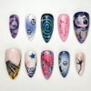 Halloween skeleton hand press-on nails in pink, navy and lilac with a silver 3D hand, button eyes and a teal spiral