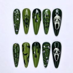 Skulls and bats press-on nails in olive and forest green with white skull masks, dark drips, stitches and silver stars