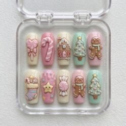 Pastel Christmas gingerbread press-on nails in pink, mint and cream with 3D gingerbread men, a candy cane and trees