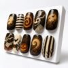 Short square press-on nails on a white stand: glowing jack-o'-lanterns, spiral and striped nails, a ghostly dog, bare trees