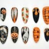Pumpkin Halloween press-on nails in orange, black and cream with ribbed 3D pumpkins, white ghosts and gold spiderwebs