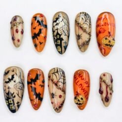 Spooky Halloween press-on nails in orange, beige and black with a haunted house, bats, gold stitches and a glitter pumpkin