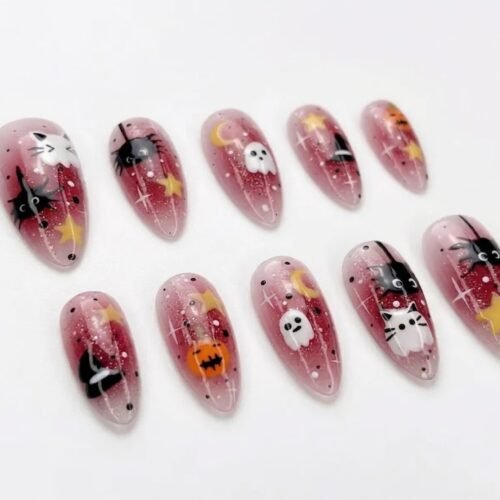 Press-on nails featuring a sparkly pink base and pumpkin designs.