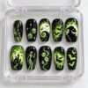 Spooky skeleton press-on nails in black and neon green with a waving skeleton, a haunted house, bats and dice
