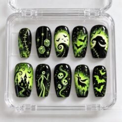 Spooky skeleton press-on nails in black and neon green with a waving skeleton, a haunted house, bats and dice