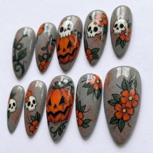 Press on nails featuring pumpkin patterns, flowers, and intricate white skulls.